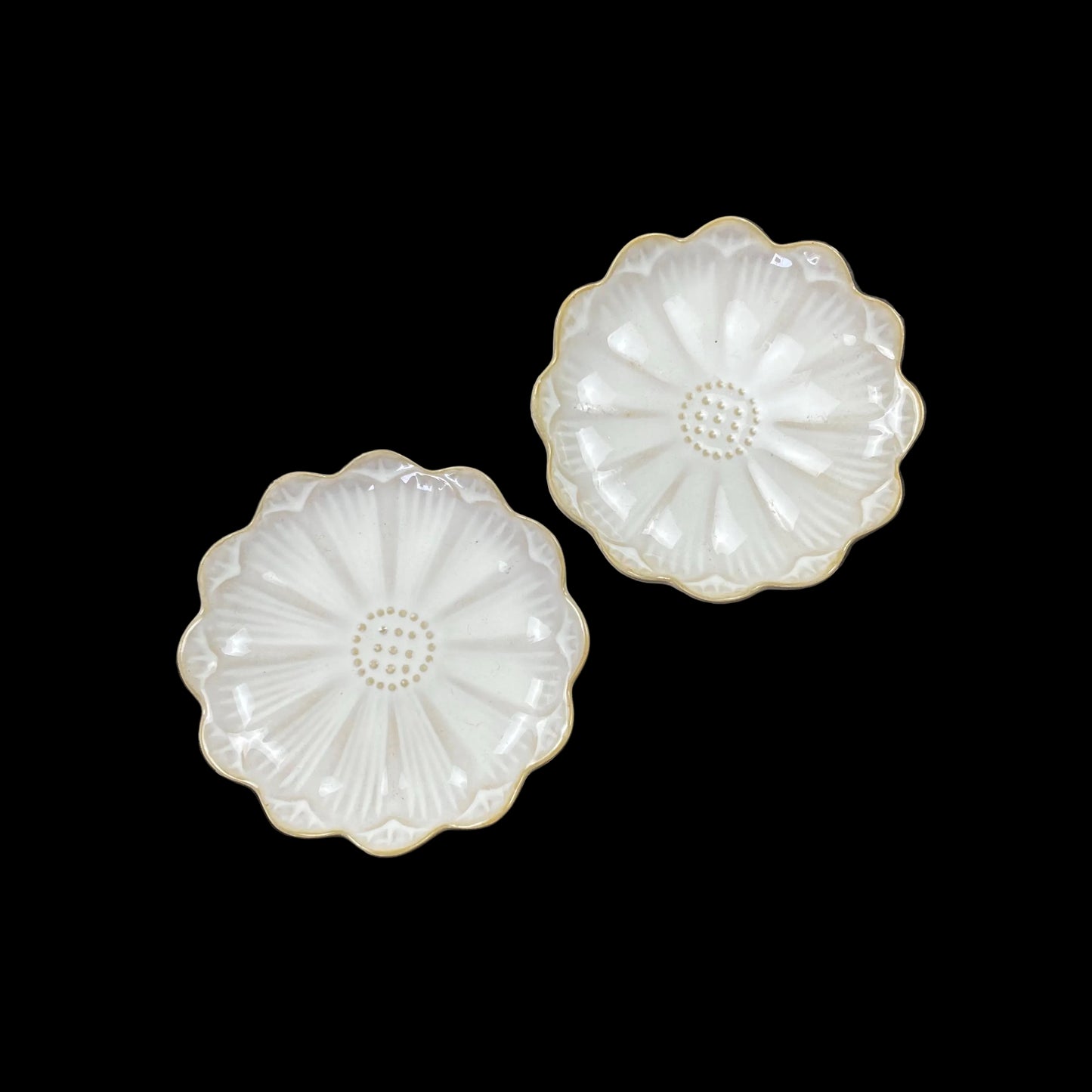white ceramic flower-shaped dish stands with gold bases