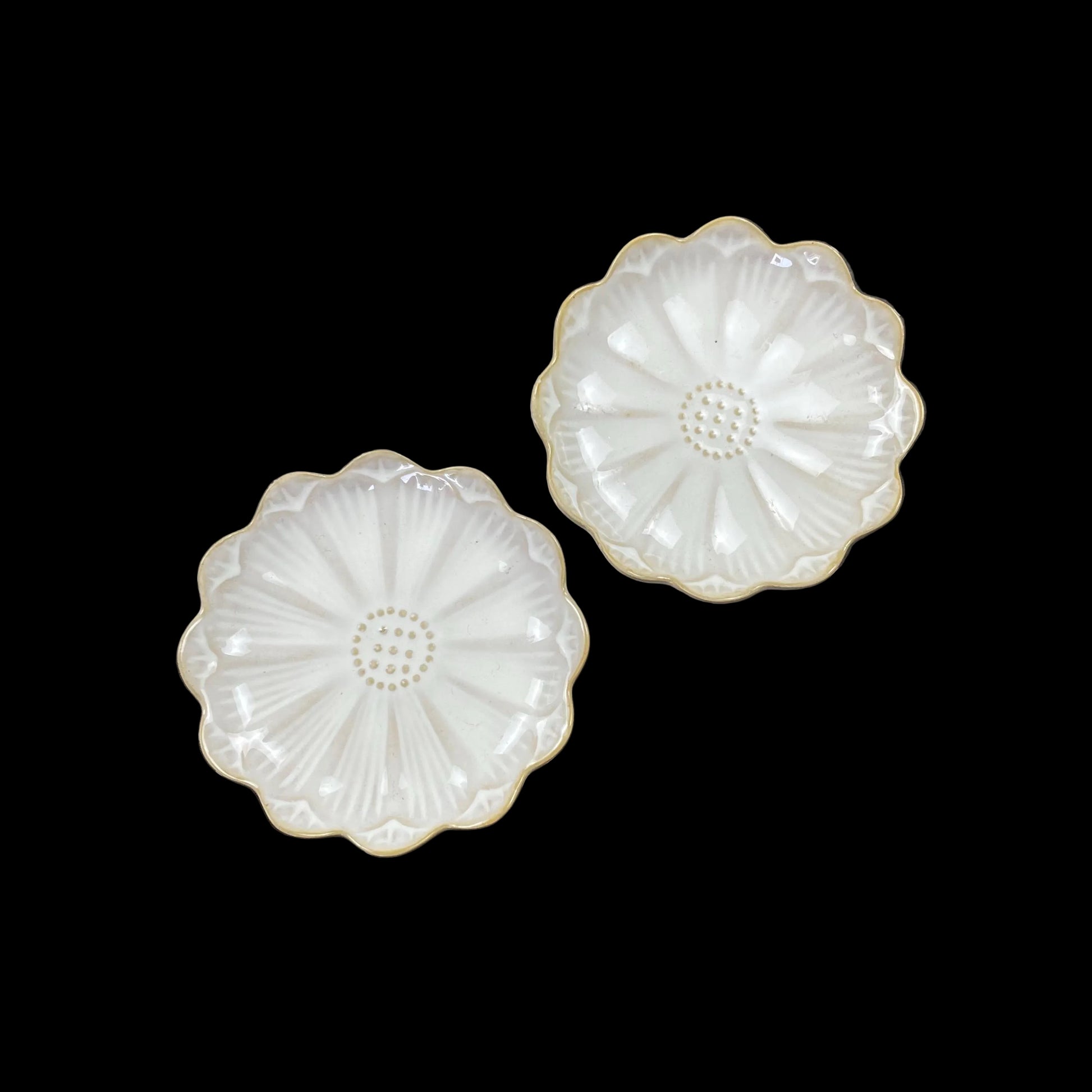 white ceramic flower-shaped dish stands with gold bases