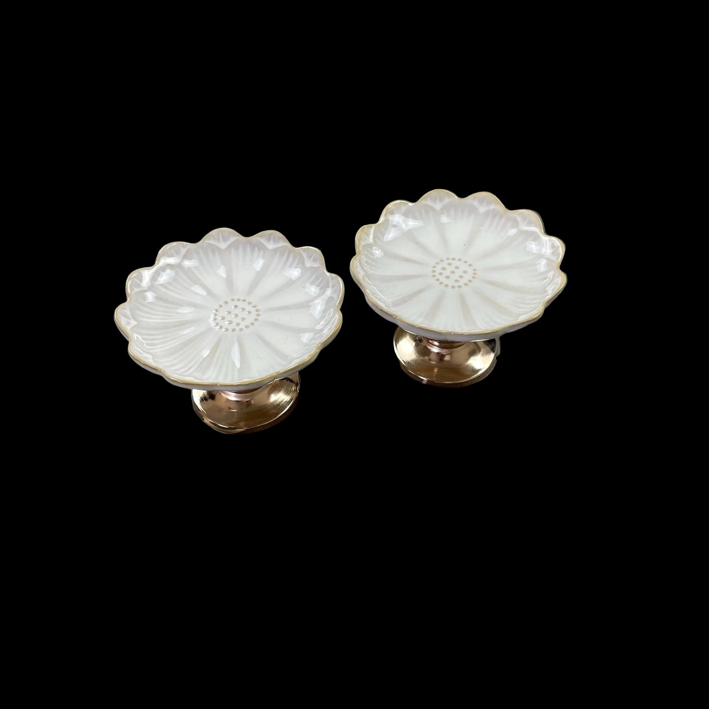 white ceramic flower-shaped dish stands with gold bases