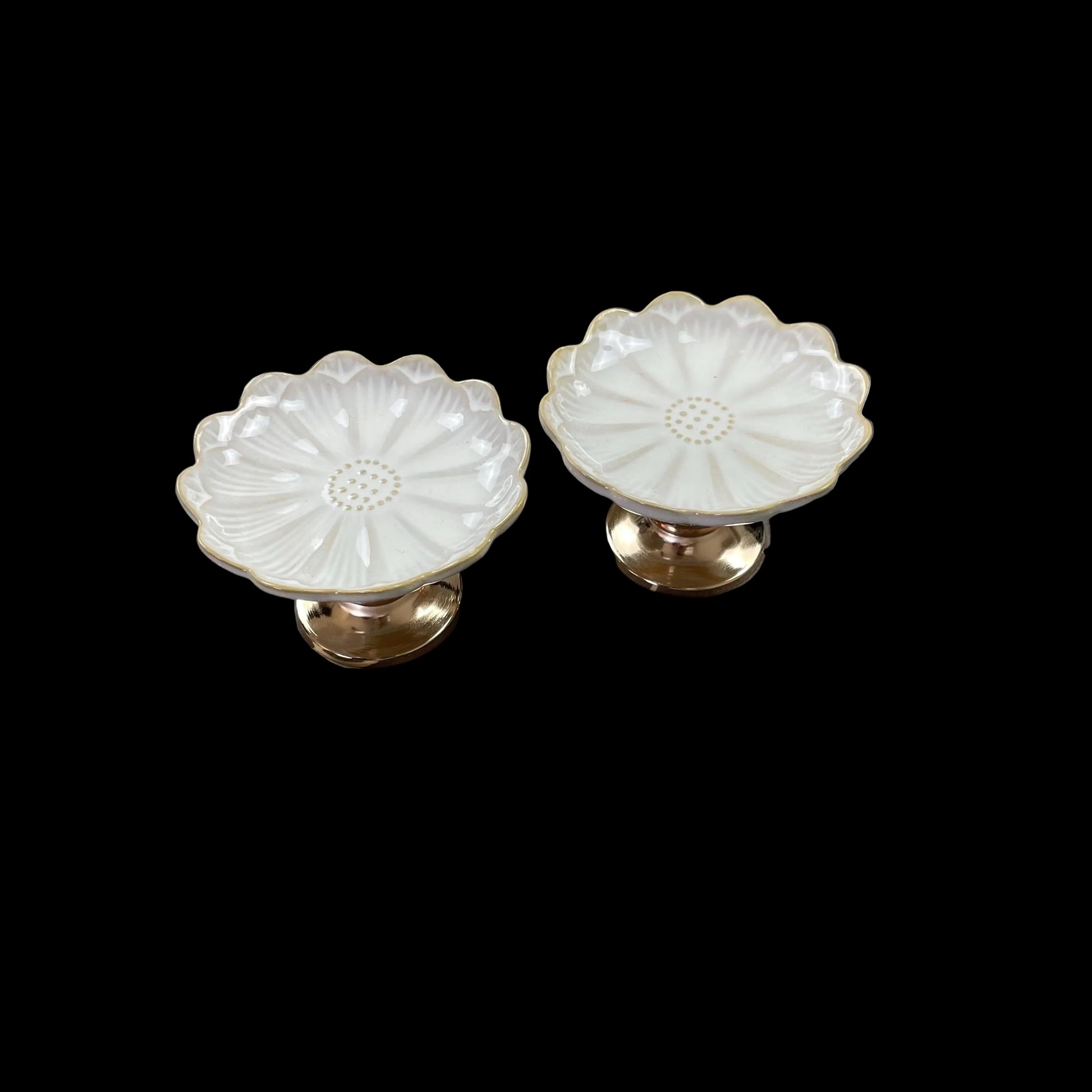 white ceramic flower-shaped dish stands with gold bases